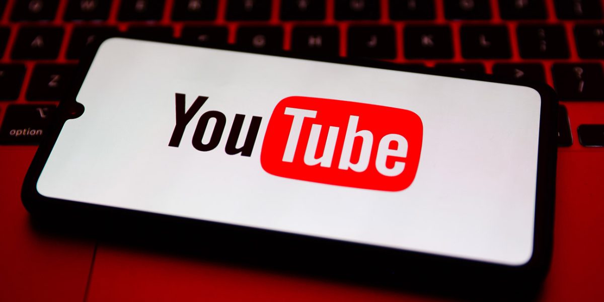 YouTube logo is displayed on a mobile phone screen