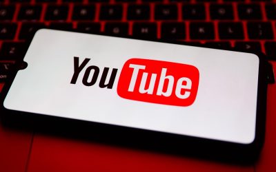 YouTube logo is displayed on a mobile phone screen