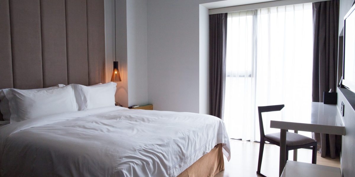 hotel-bedroom-with-double-bed-table-tv-set-scaled.jpg - NewsFactor